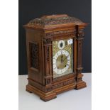 Late 19th / Early 20th Century Lenzkirch carved oak bracket clock, the brass dial with silvered