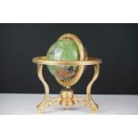 Table top globe made from semi precious stone with compass set to base, raised on three gilt metal