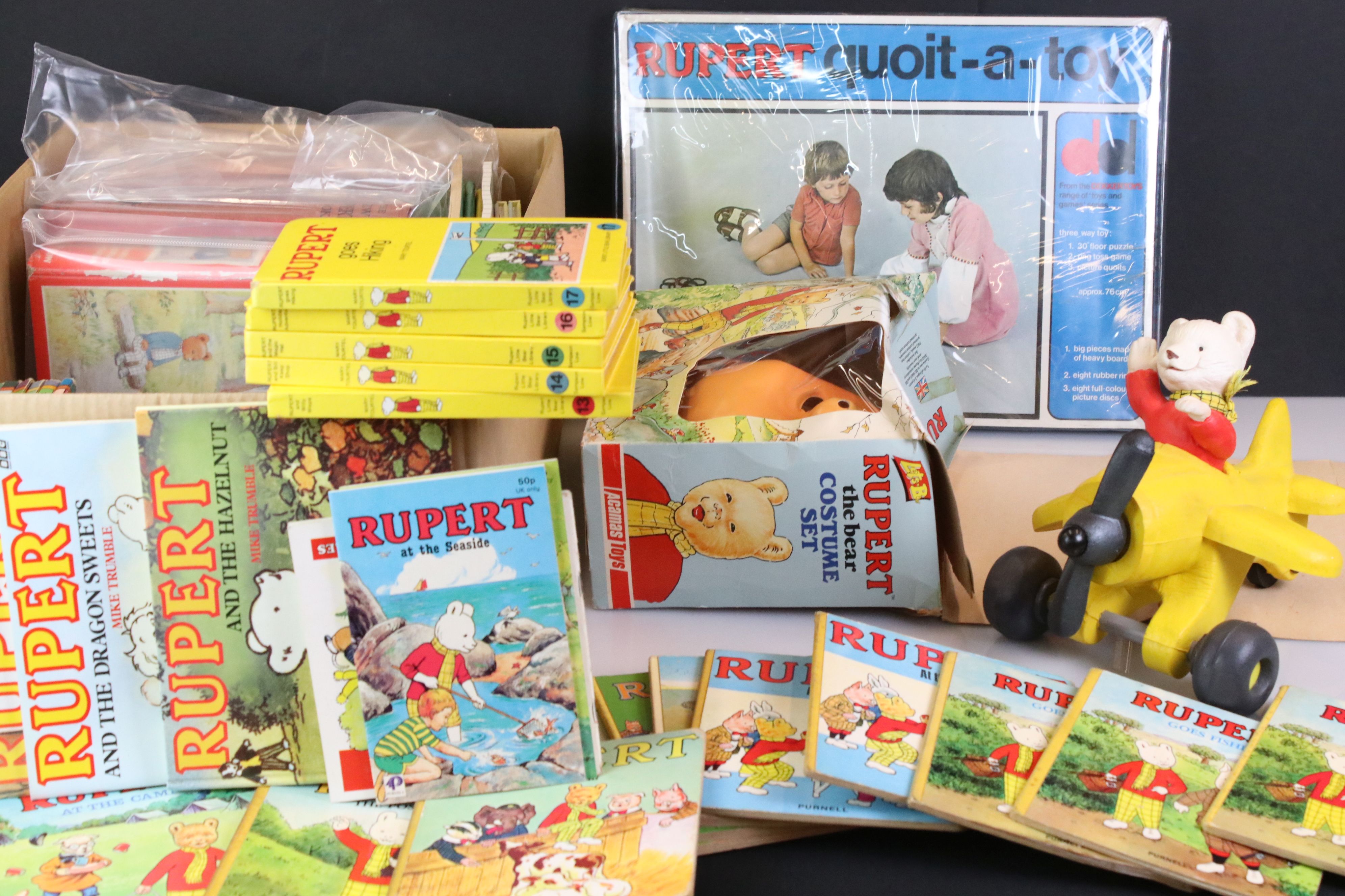 A large group of Rupert the Bear collectables to include books, toys, games and costume.