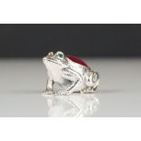 Silver pincushion in the form of a frog with emerald eyes