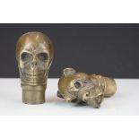 Two brass walking stick handles to include a skull and a bulldog example.