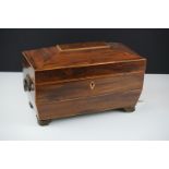 Early 19th century rosewood veneered & satinwood strung sarcophagus tea caddy, with brass foliate