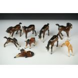 Seven Beswick porcelain foals, mostly brown gloss examples, tallest approx 13cm, all with printed