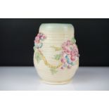 Clarice Cliff Newport Pottery vase of baluster form, with polychrome moulded blossom decoration on a