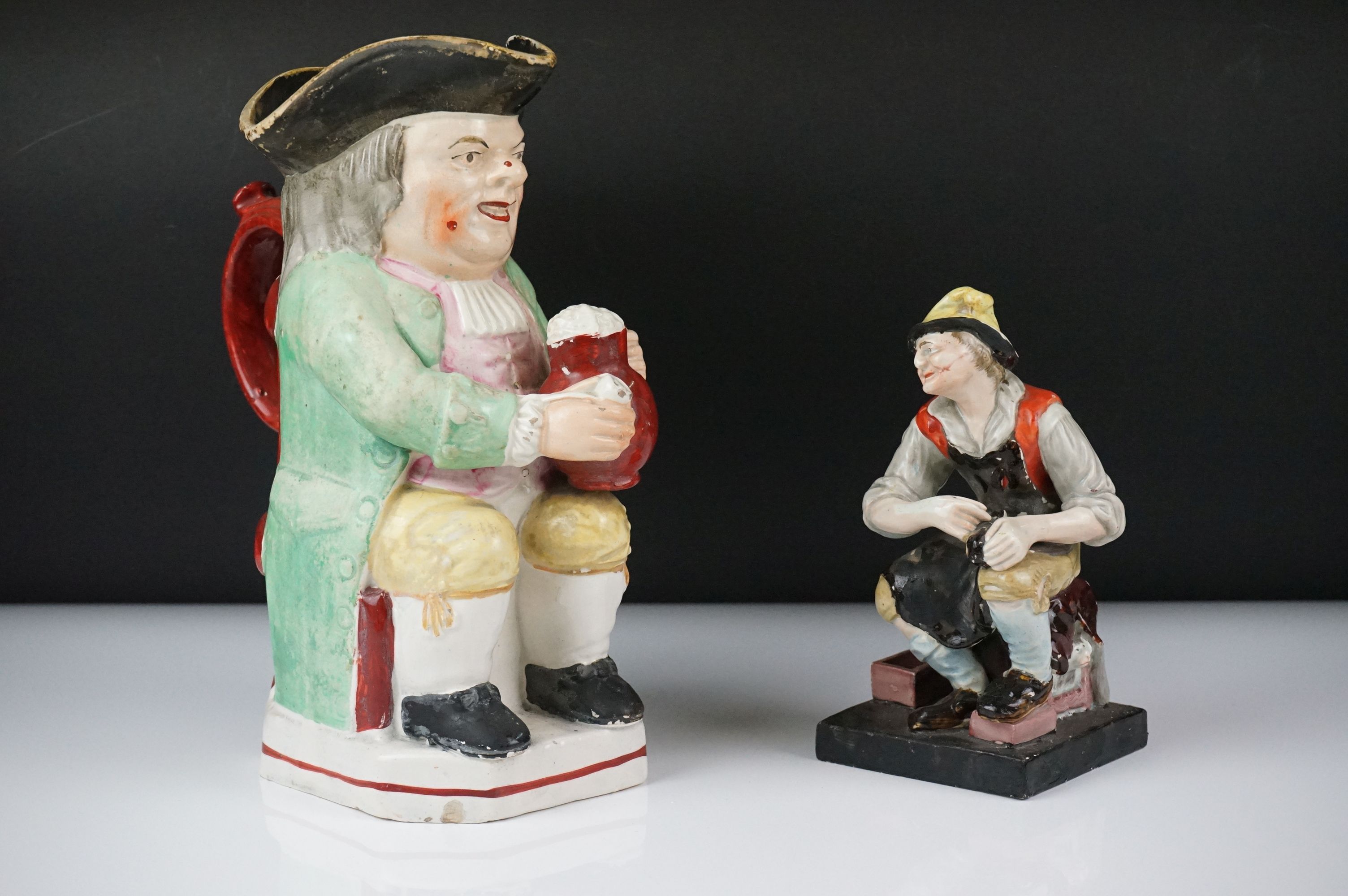 19th Century Staffordshire Toby jug modelled as Toby Philpott holding a foaming tankard and pipe,