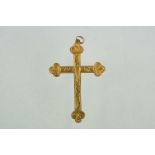 A hallmarked 9ct gold cross pendant with engraved decoration.