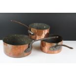Pair of Copper Graduating Saucepans with Iron Handles, stamped to side P.L., together with a similar