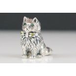 Silver figure of a cat with emerald eyes