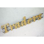 ' Traders ' wooden wall sign mounted on cast iron wall brackets, approx 120cm long