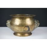 Chinese brass censer with relief dragon mask decoration raised on a circular foot, approx 11cm high