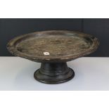 Antique large oak circular cake stand with a plain carved top raised on a turned foot, approx 48cm