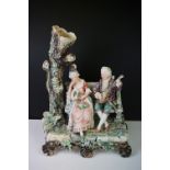 19th Century porcelain figural spill vase of a 19th Century courting couple on bench with tree,