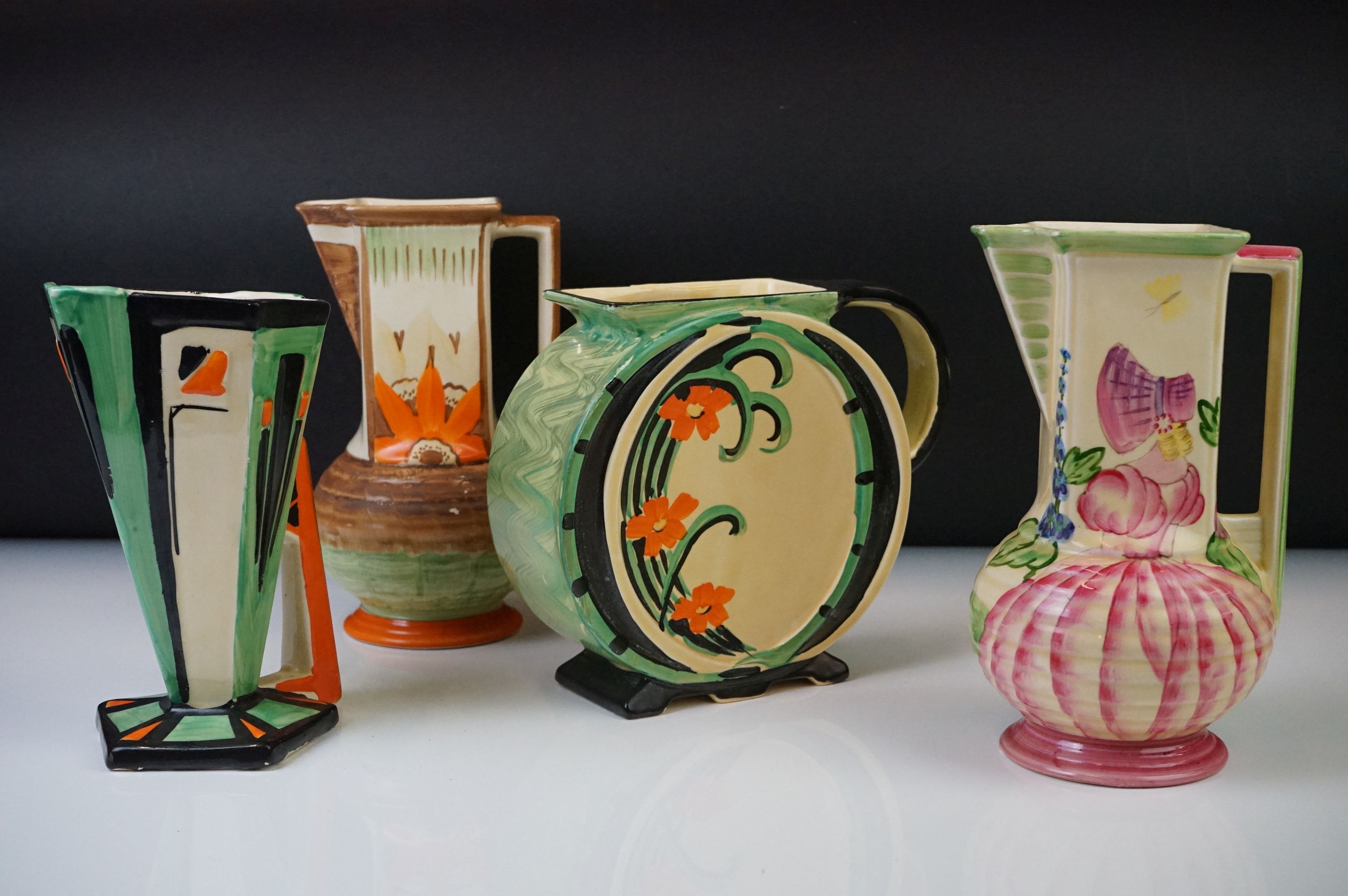 Four Myott, Son & Co hand painted Art Deco jug vases, decorated with floral, foliate and geometric