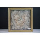 Framed montage containing silk flowers, paper cherub, imitation pearls, silvered heart-shape