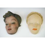 Two Leonardi Art Deco painted plaster wall masks depicting young ladies, both with impressed