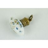 Miniature white porcelain torpedo shaped scent bottle with hand painted forget-me-nots, brass