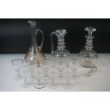 Three cut glass decanters with star-cut bases to include two in the form of ewers and another with a
