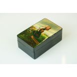 A Russian lacquer box, signed Podwchicko (?) with a young mother carrying her child on her back,