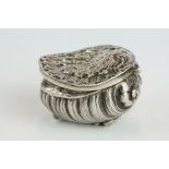 Unmarked silver snuff box modelled as a stylised shell, three cast scroll feet, cast hinged lid,