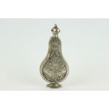 White metal scent bottle of footed flask form, circa 1760, rose and floral decoration front and