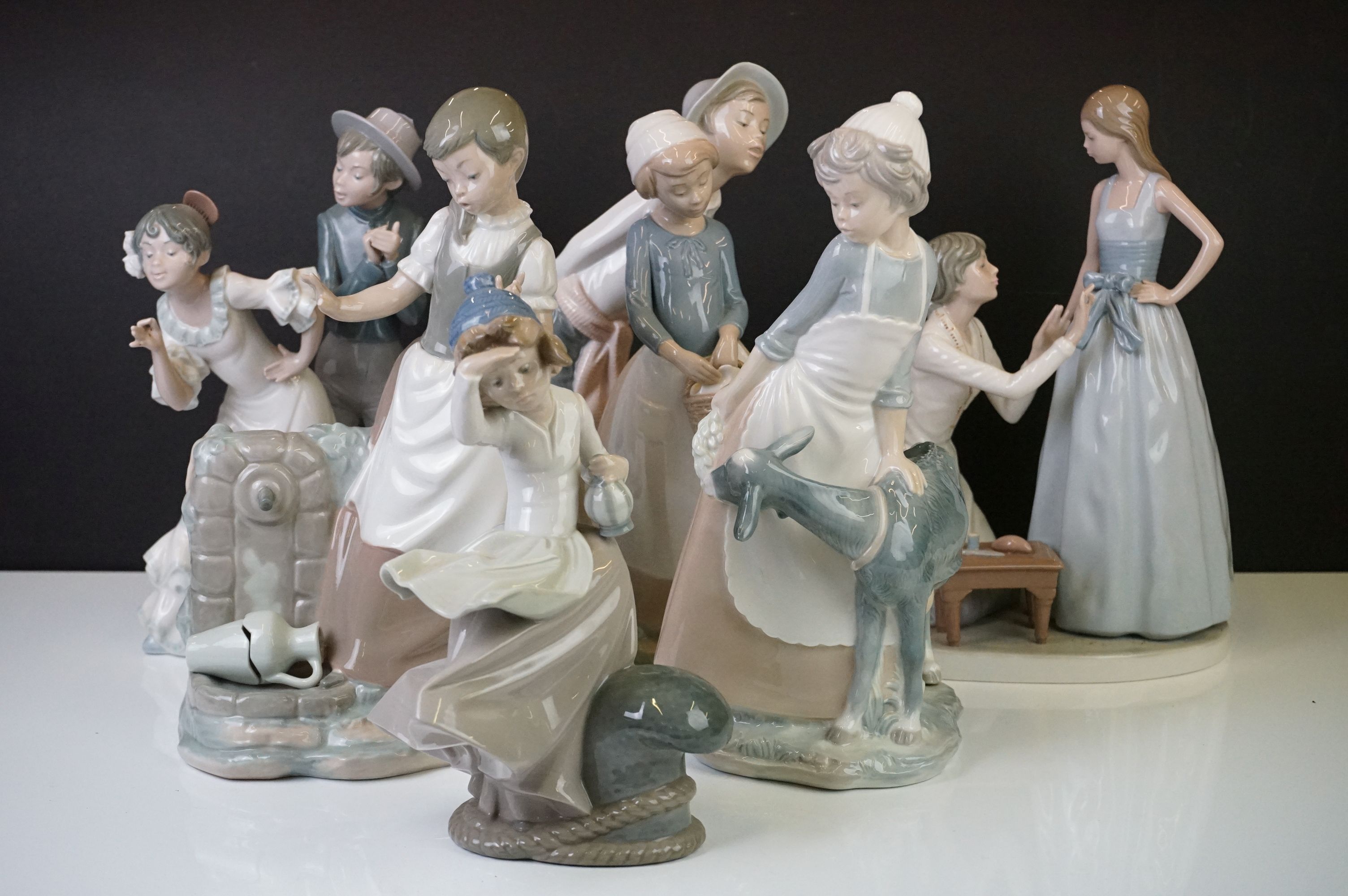 Six Nao by Lladro porcelain figures to include a girl with a goat (29.5cm high), a tailor and a