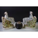 Pair of Staffordshire rearing zebra porcelain figures on a naturalistic ground, 16cm high,
