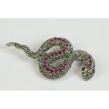 A silver, marcasite and ruby set snake brooch