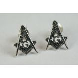 A pair of silver stud masonic earrings