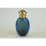 Blue glass scent bottle, yellow metal lid with engine turned decoration, opening to reveal