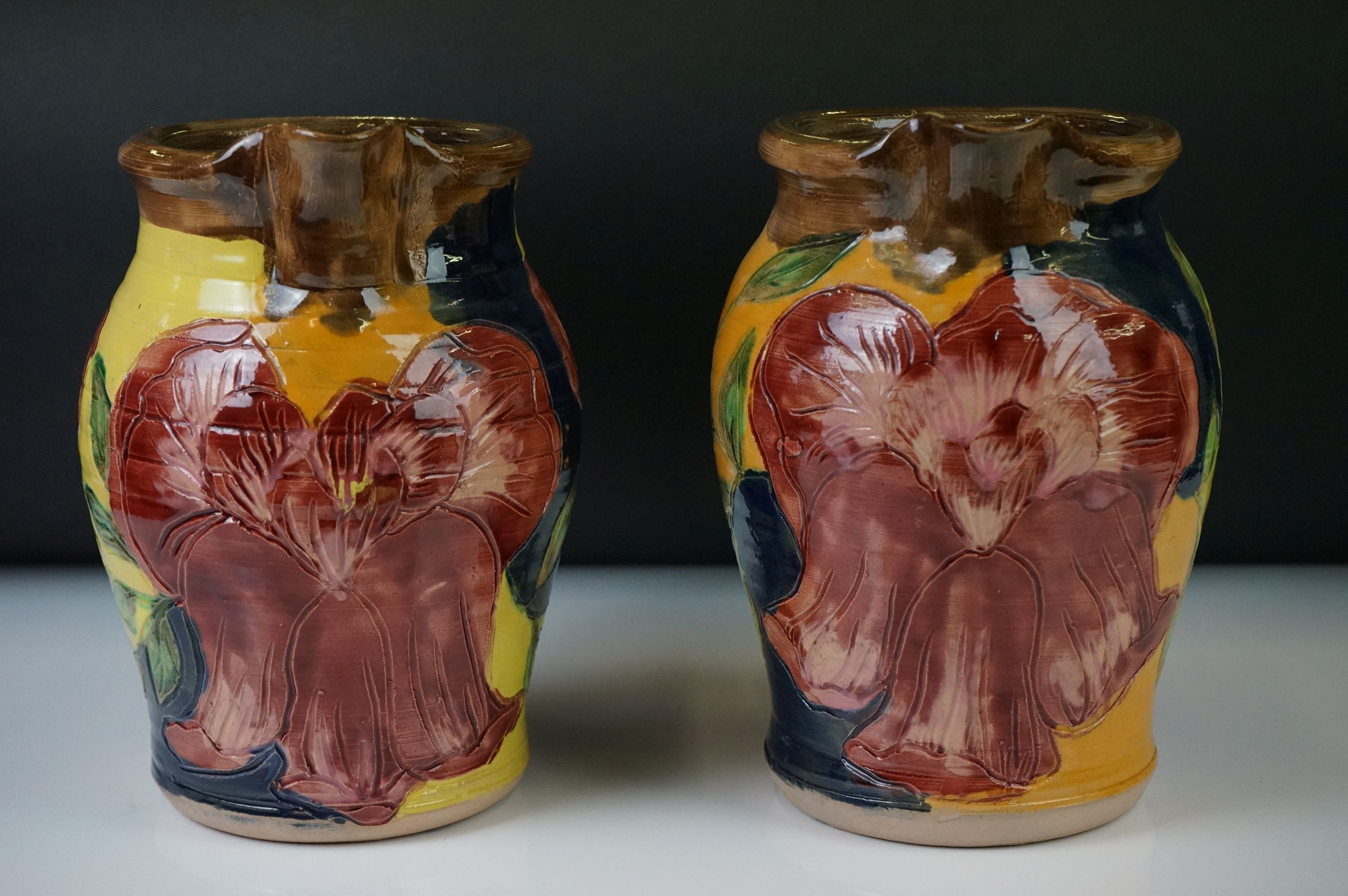A pair of pottery jug vases of baluster form, with incised floral and foliate decoration and - Image 2 of 6