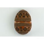 Coquilla nut pomander with carved and pierced repeating circle decoration, length approx 7cm