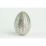 Early 18th century German white metal pomander modelled as an egg with engraved zig-zag