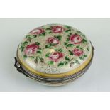 Continental ceramic and white metal circular trinket box with hand-painted roses to the outside