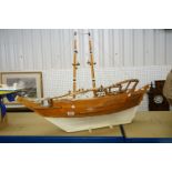 Scratch-built painted wooden model of a sailing ship, with two masts, sails and rigging details,