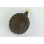 Carved Persian nut scent bottle, bone ogee finial, the spherical body with carved floral and