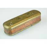 An antique 18th century brass and copper snuff box with ornate chased decoration.