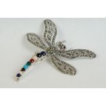 A silver dragonfly brooch set with marcasites, sapphires, rubies etc