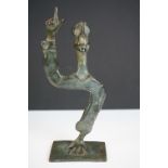 Israeli bronzed metal sculpture of a stylised figure balancing on one hand, signed and dated 1989,
