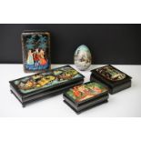 Four Russian black lacquer boxes with hinged lids, decorated with pictorial figural scenes,