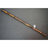 Asian carved bamboo sword stick with brass collar and bands of floral and foliate decoration to