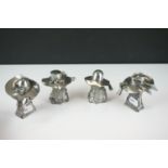 A collection of four contemporary white metal hat ornaments, maker marked to verso.