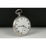 A vintage top winding pocket watch in white metal case with sub second dial to 6 o'clock.