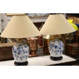 Pair of Blue and White Ceramic Baluster Double Branch Table Lamps decorated with leaves, 66cm