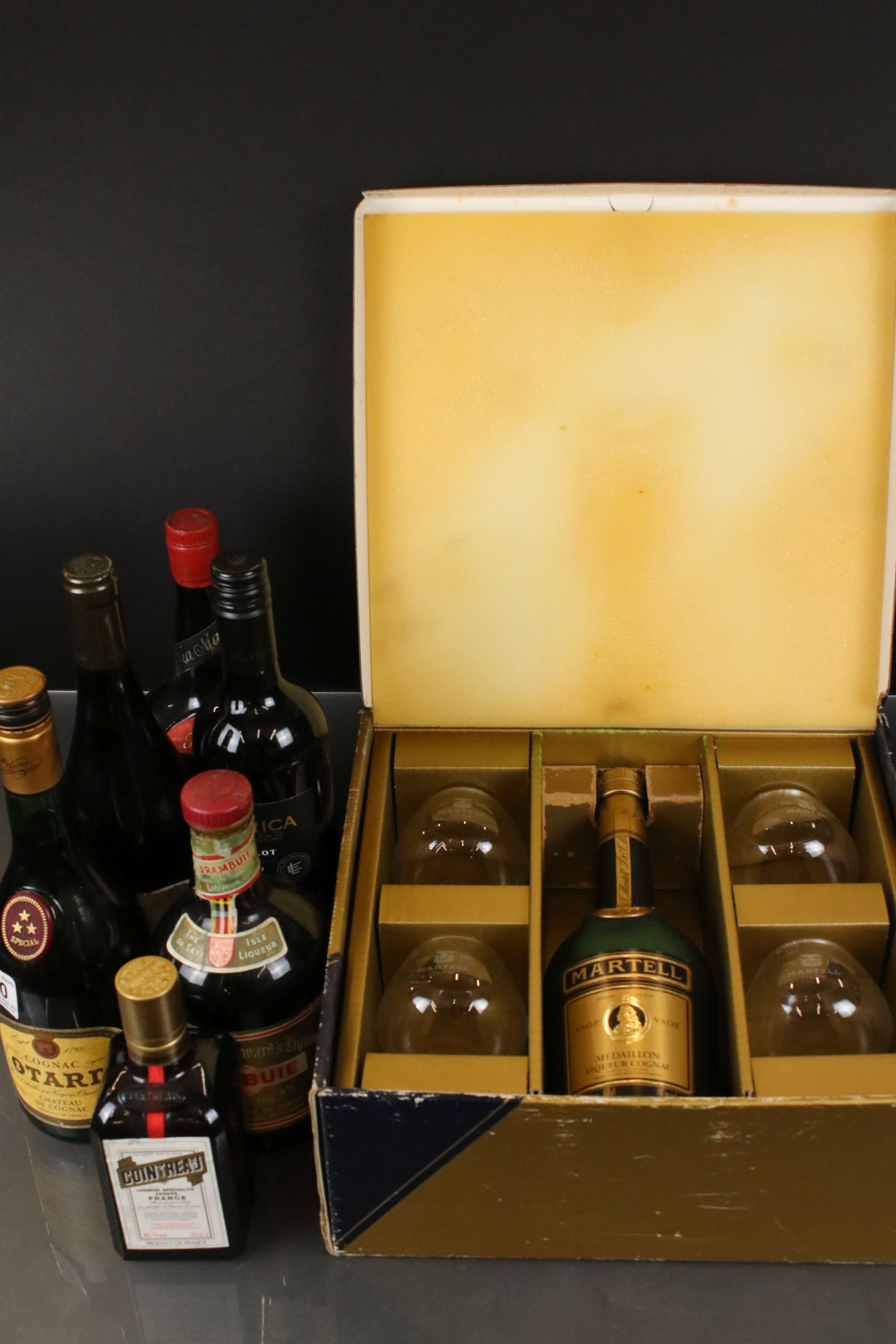 A collection of bottled spirits to include Drambuie, Cointreau, Tia Maria, Martel Cognac ...etc..