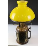Table Lamp, the metal wood effect base covered with a brass and white metal band, holding yellow