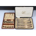 A cased set of six fully hallmarked sterling silver coffee bean spoons together with a set of