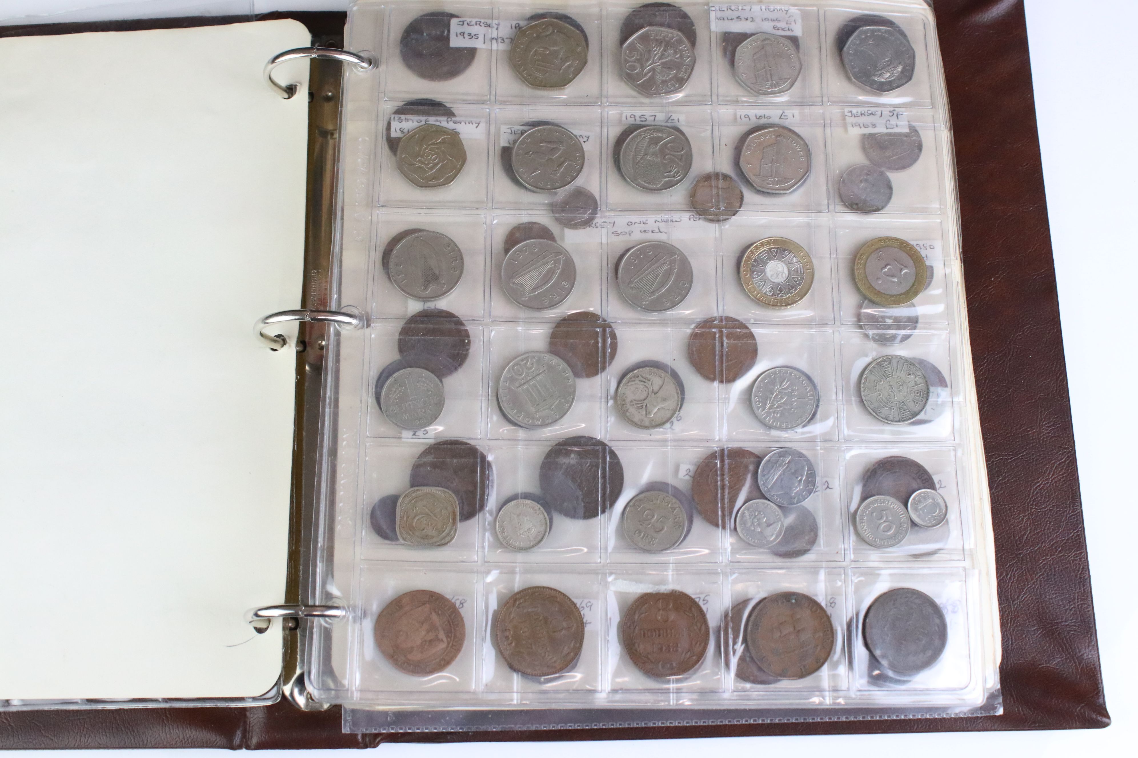 A large collection of foreign coins contained within an album to include Belgium, Spain, Ireland,