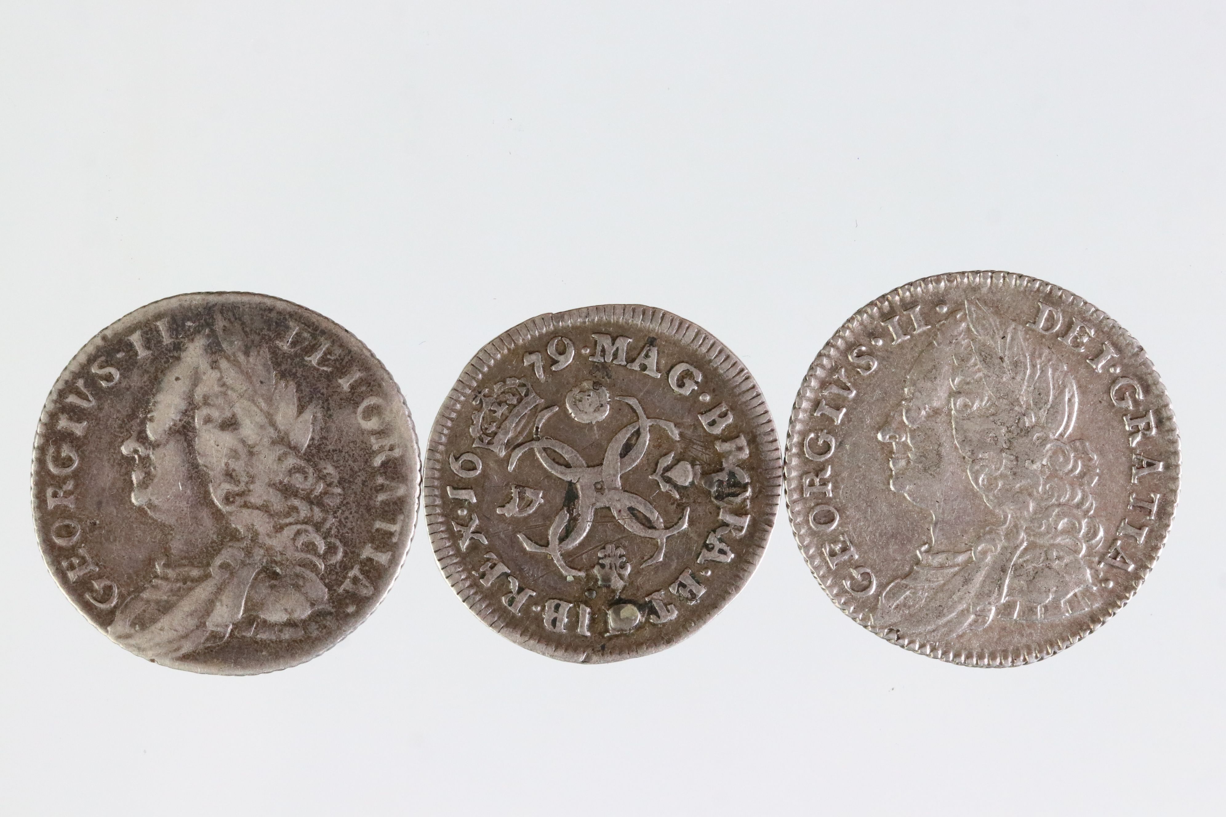 Three early milled British silver coins to include a King Charles II sixpence dated 1679 and two