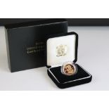 A British Royal Mint 2000 Millennium full gold sovereign coin in proof condition, complete with