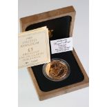 A British Queen Elizabeth II 1989 £5 brilliant uncirculated gold coin, complete with display box and